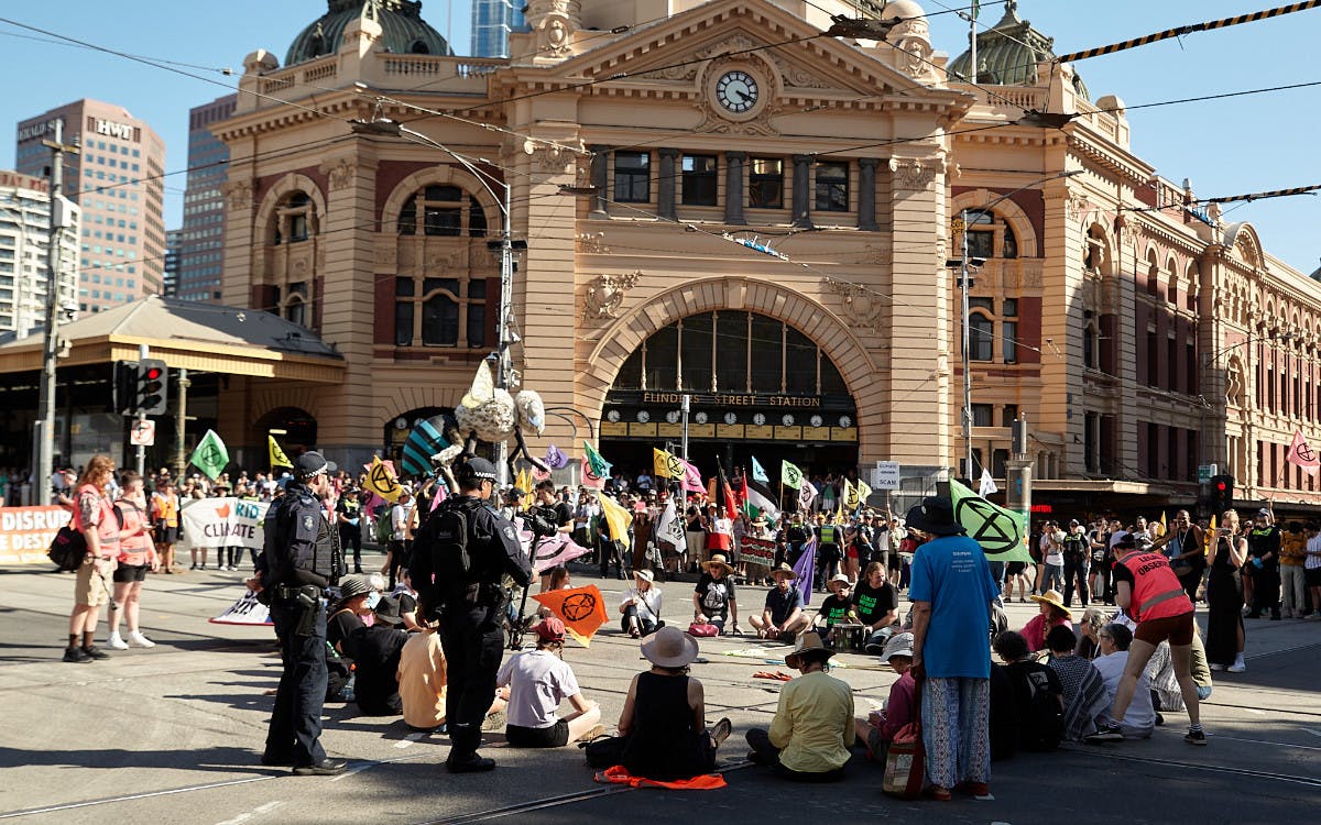 mass sit down in the road in front of Flinders Street Station