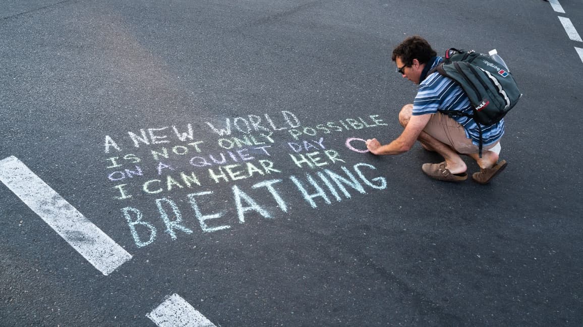 Message of hope being chalked on the pavement