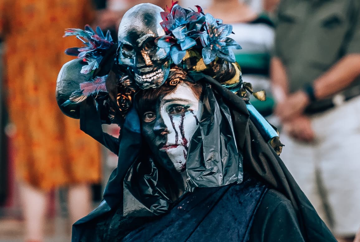 Rebel wearing an expressive headdress at the funeral procession