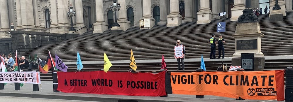 Banners outside State Parliament: 'A better world is possible', 'Vigil for climate'. Photo credit: Leslie F