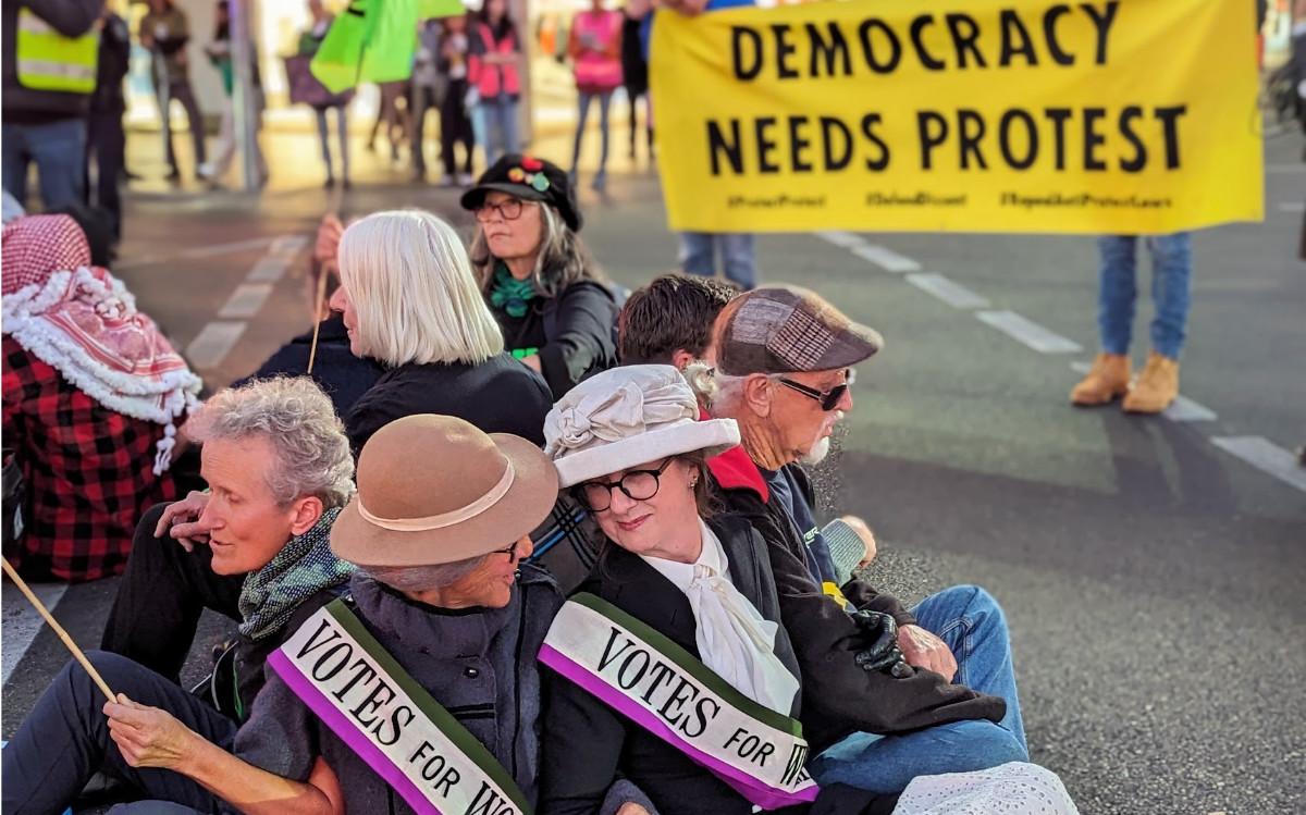 Protesters wearing 'Votes for Women' sashes