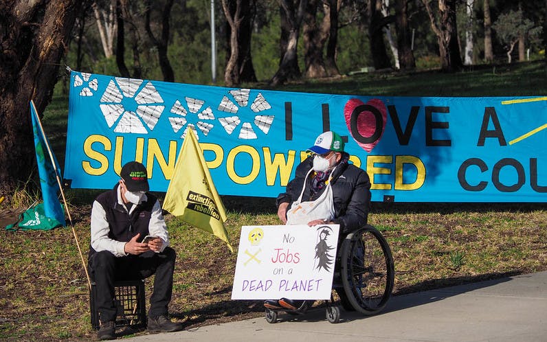 Banner calling for solar power on the road to Parliament House, ACT