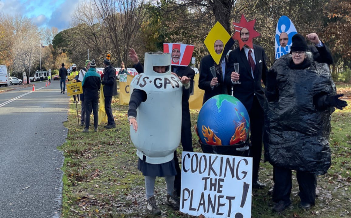 Demonstrators in costume by the road to Government House in Canberra