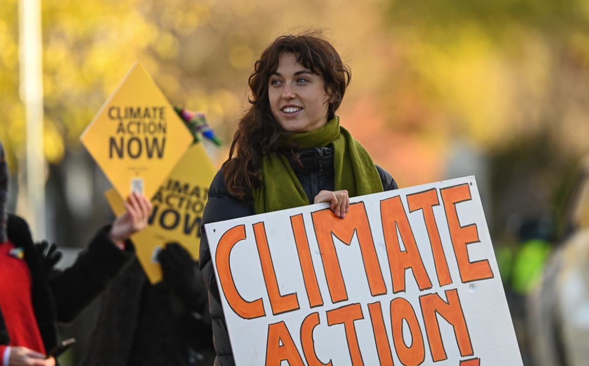 Protester holding climate action banner