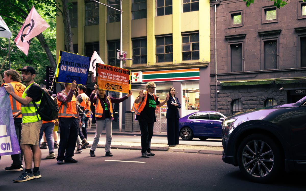 Rebels face traffic during a slow march in Melbourne's CBD - photo by Leo Mace