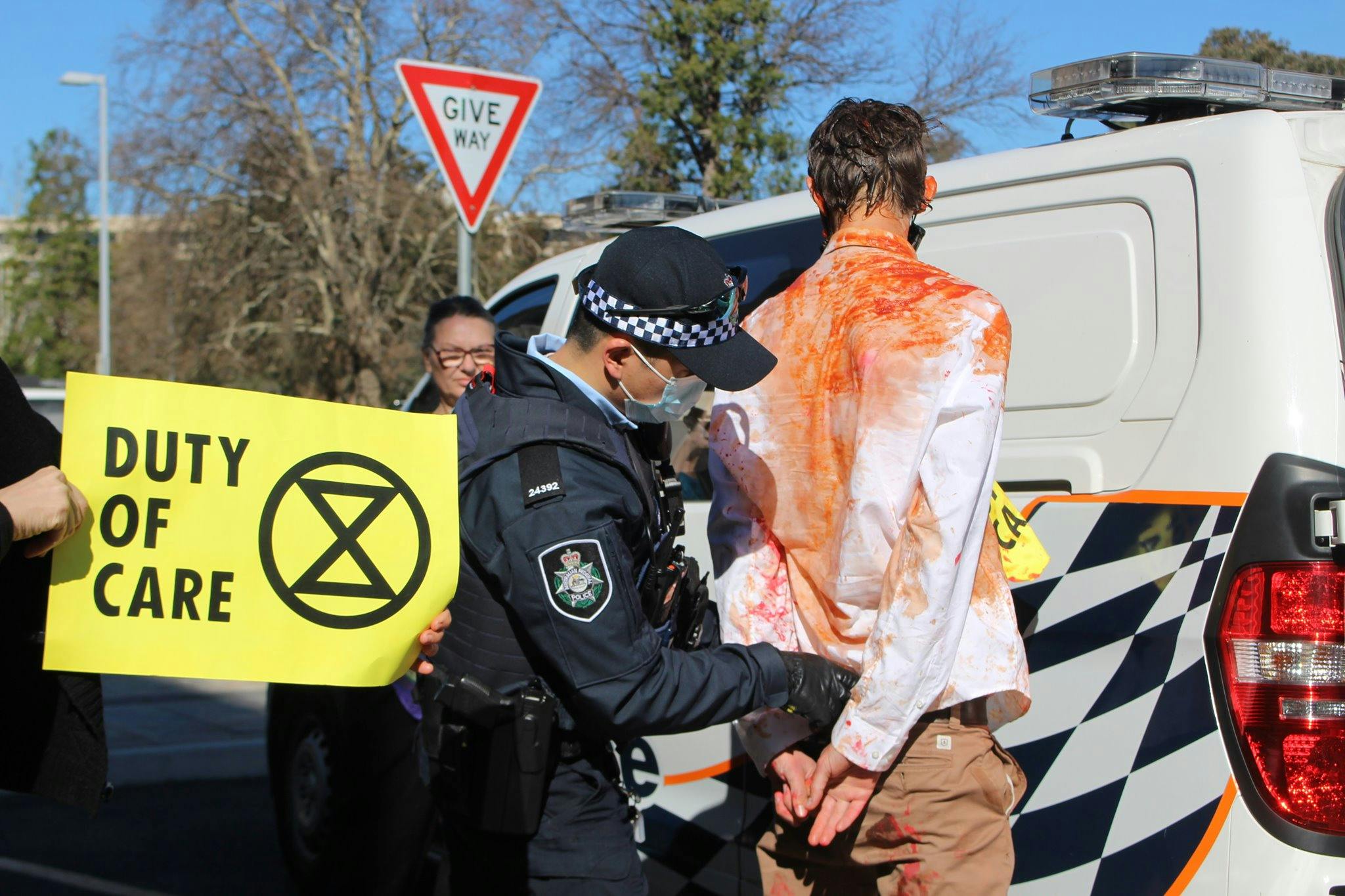 XR rebel being arrested in Canberra, August 2021