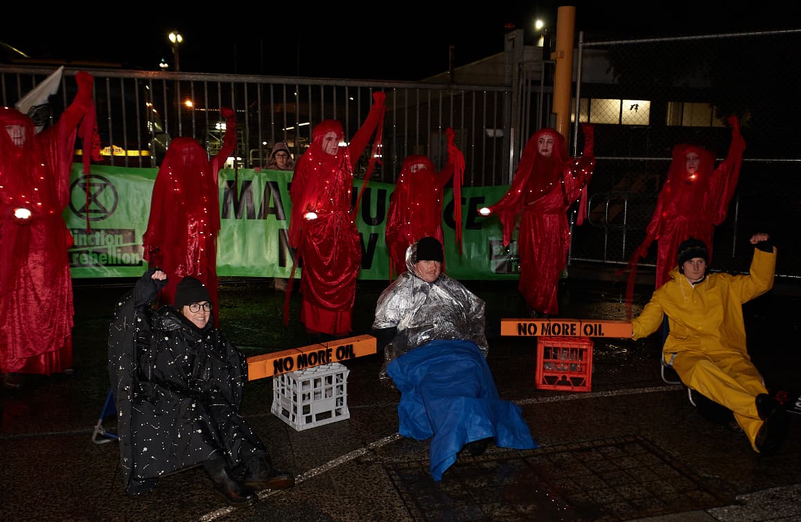 Cat, Mark and Adam and Karen locked on outside the Exxon Depot