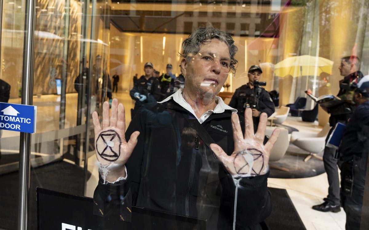 Protester glued to the front window of the Future Fund