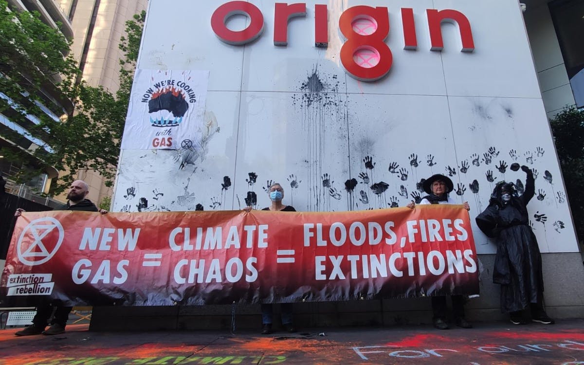 Protesters with banner outside Origin Energy