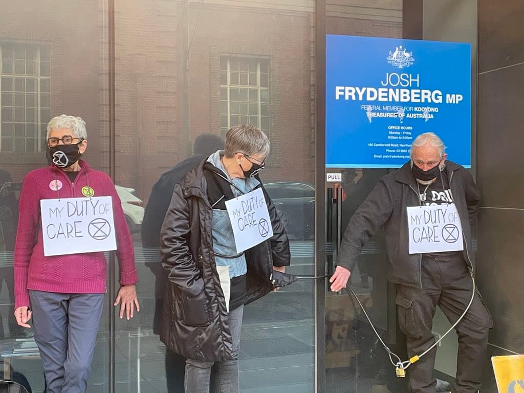 XR Rebels with hands glued to Josh Frydenberg's office windows