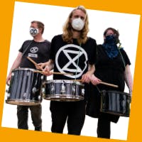 Three drummers wearing black with XR logos