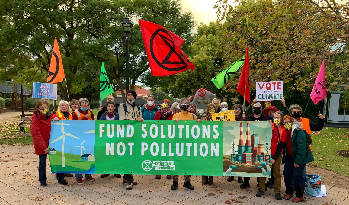 Rebels holding banner - Fund Solutions Not Pollution