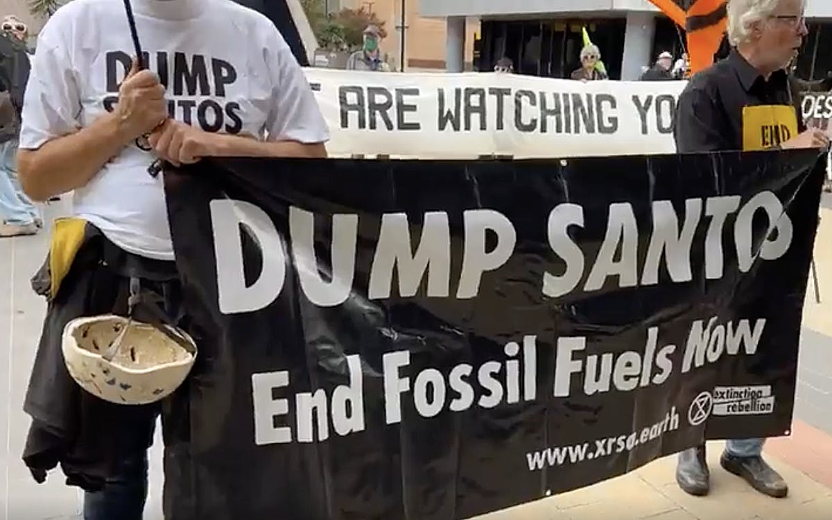 Protesters with banners at the Santos 2023 AGM