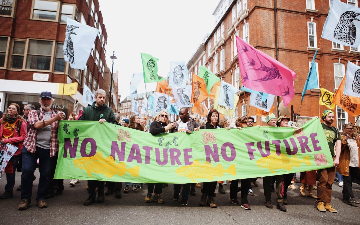 Crowd holding banner saying No Nature, No Future