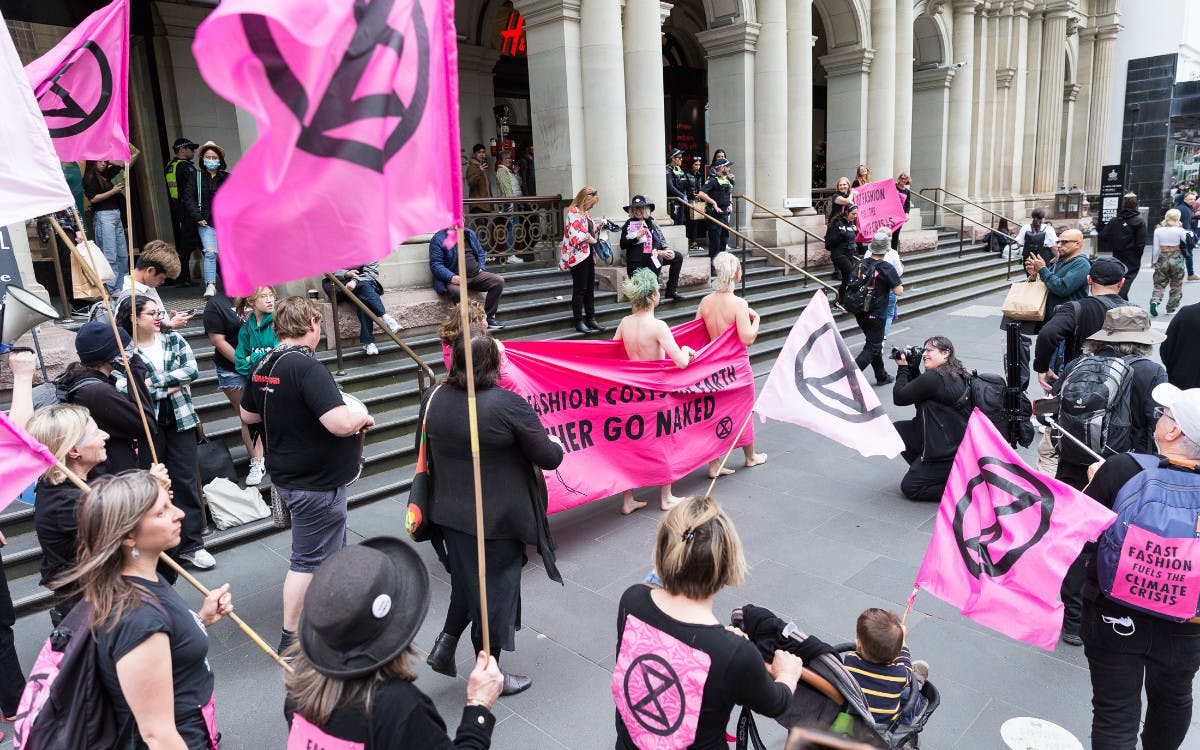 XR activists parade through Bourke Street mall with a banner