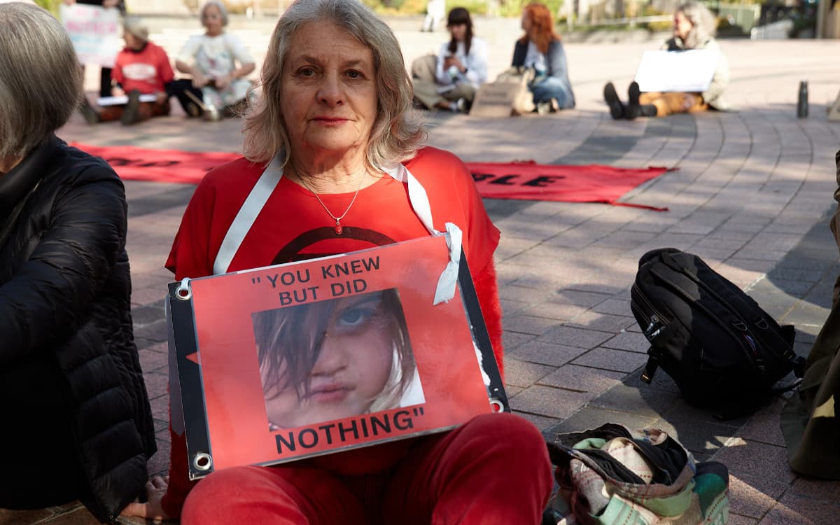 Woman with sign including a photo of a child