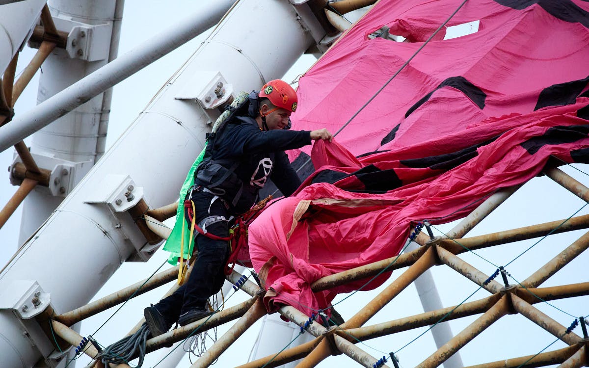 Protester climbing the Arts Centre Spire