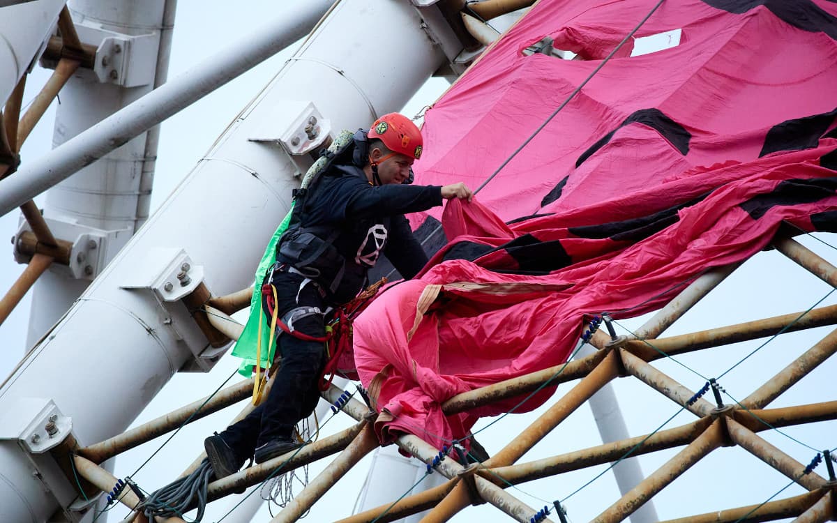 Protester climbing the Arts Centre Spire