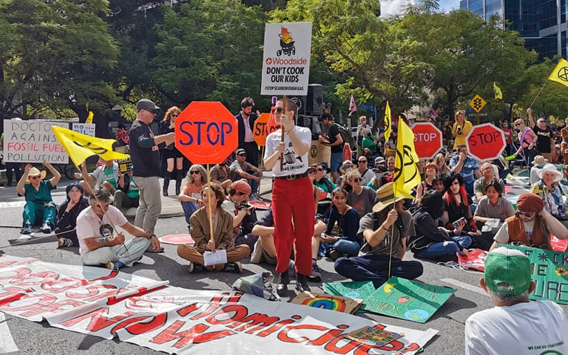 Protesters sitting outside the Woodside head office.