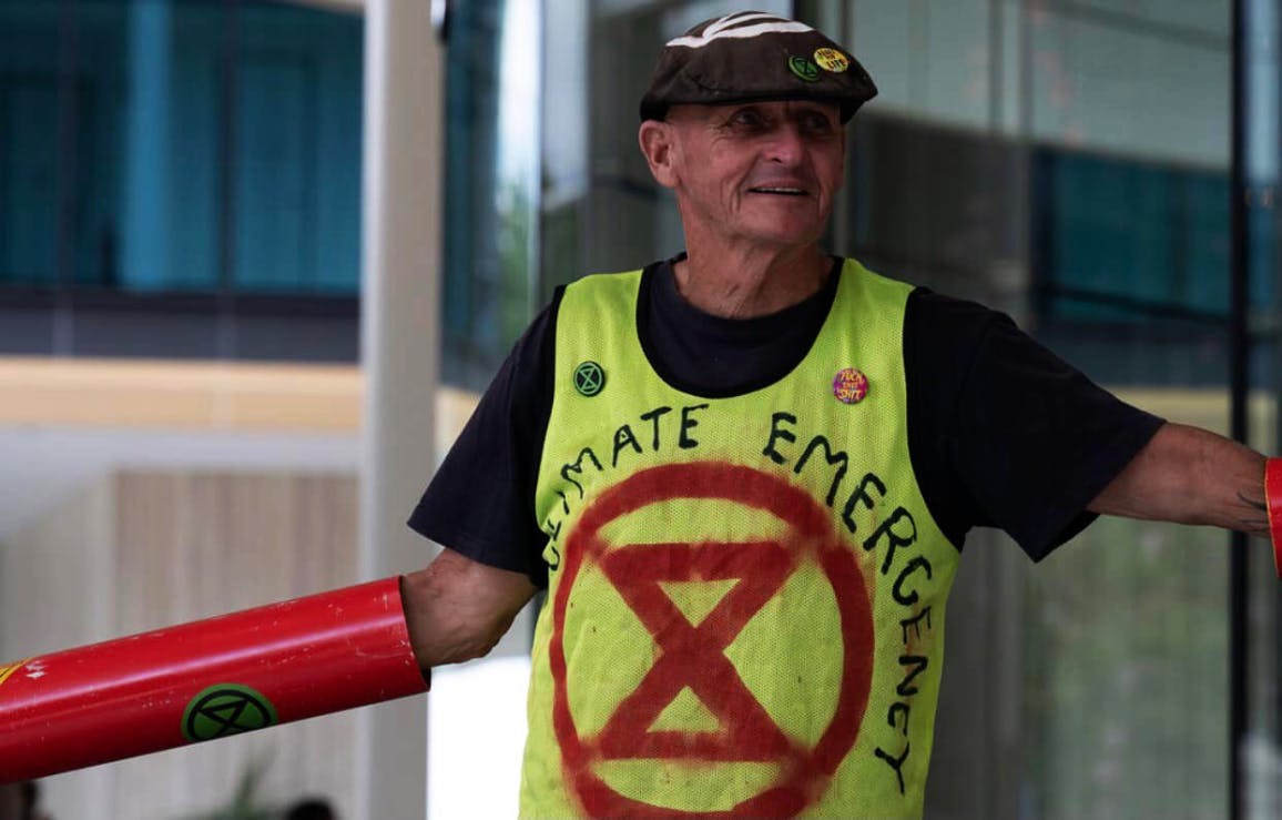 XRWA Grandparents Protester in green 'Climate Emergency' top Locked on