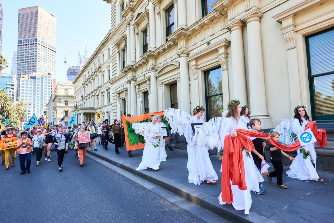 Photograph of XR activists led by the Climate Angels through Treasury Gardens.