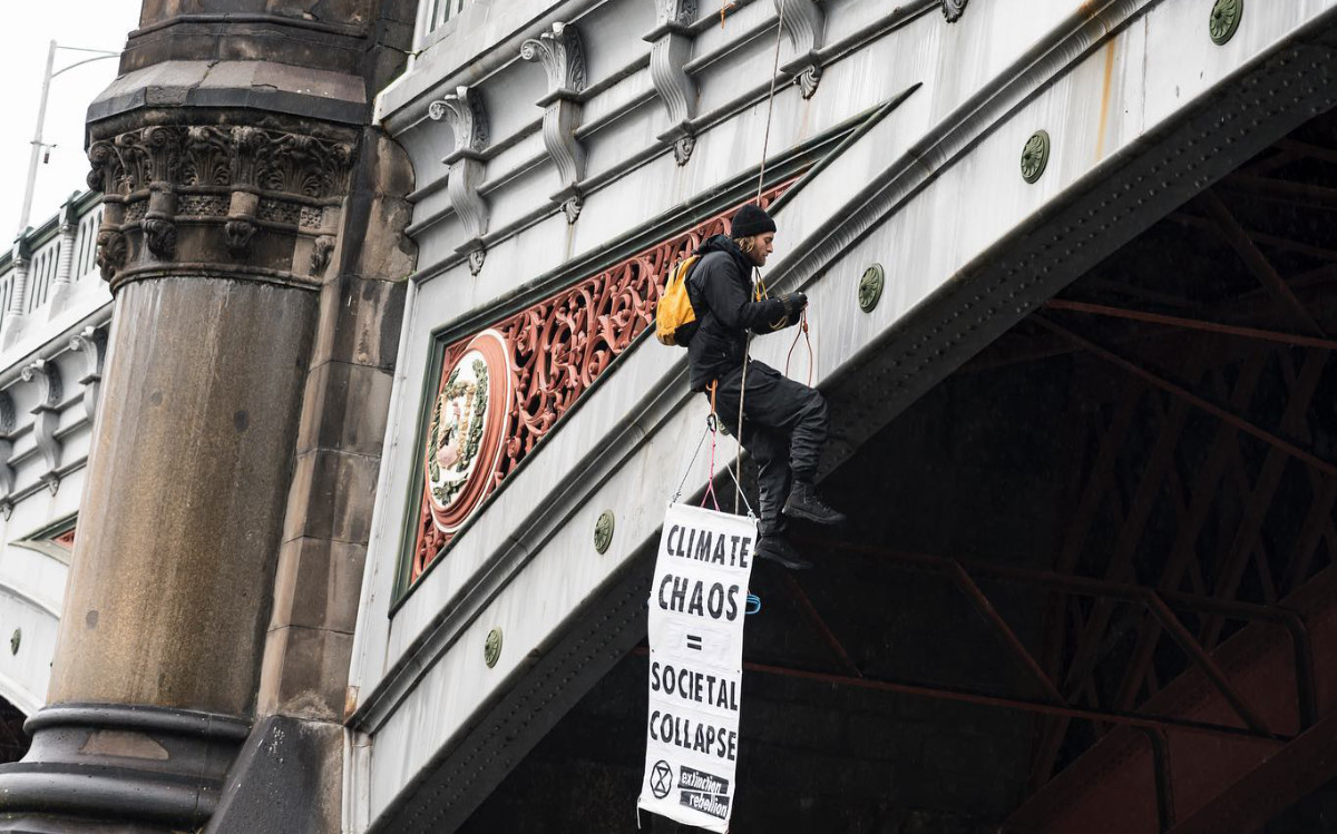 Rebel hanging on a rope from the Princes Bridge