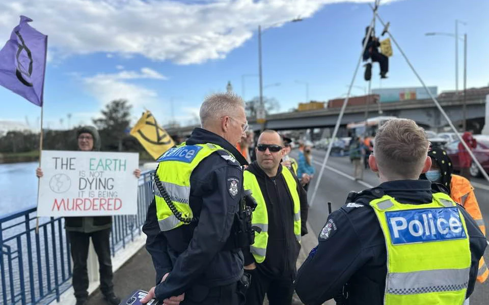 Bridge Punt Road  blocked by a protester suspended on a tripod