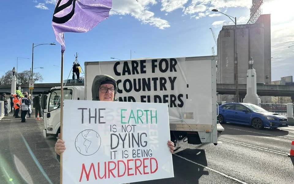 Protester's van blocking Punt Road with a sign 'Care for Country, Care for Elders'