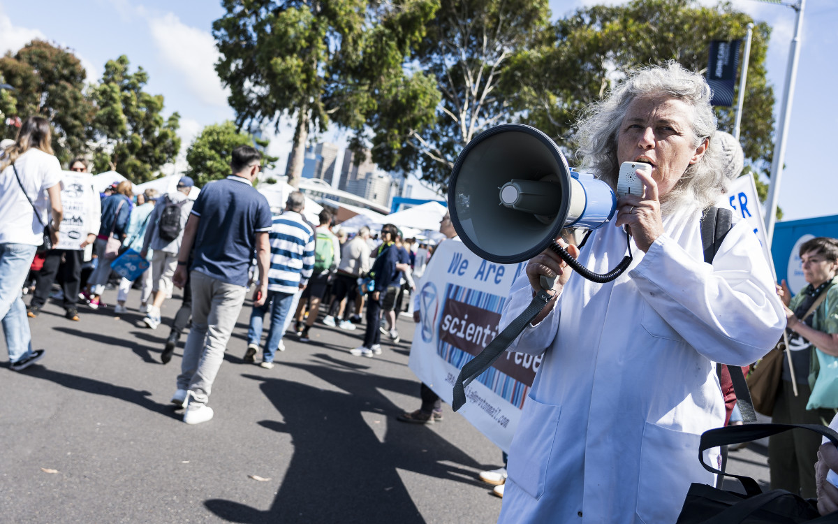 Scientist Rebellion rebel holding a loudspeaker
