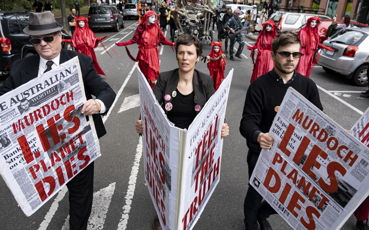 Parade participants in costume with giant newspapers as props