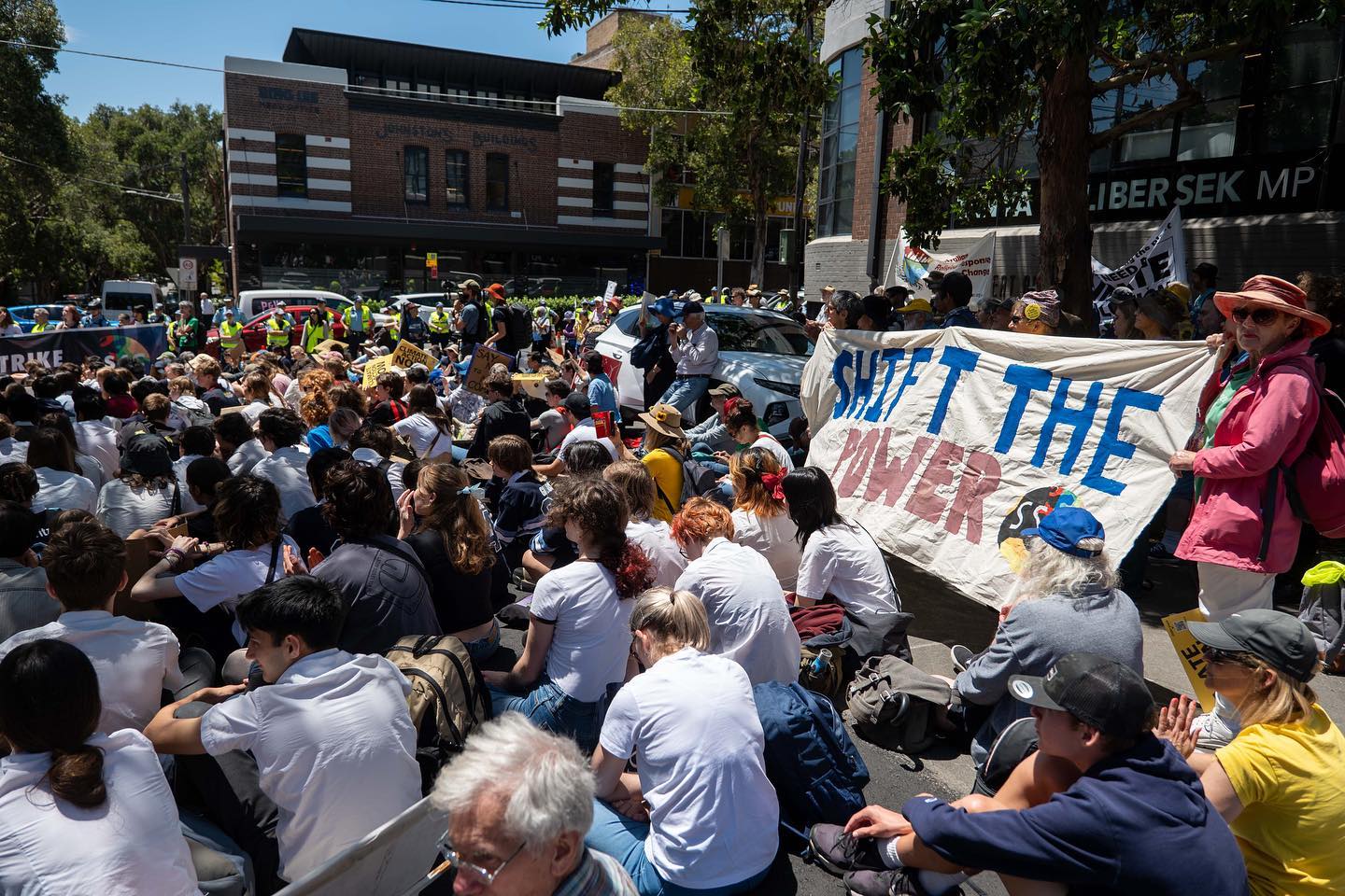 Marchers sitting outside the office of Tanya Plibersek, federal environment minister