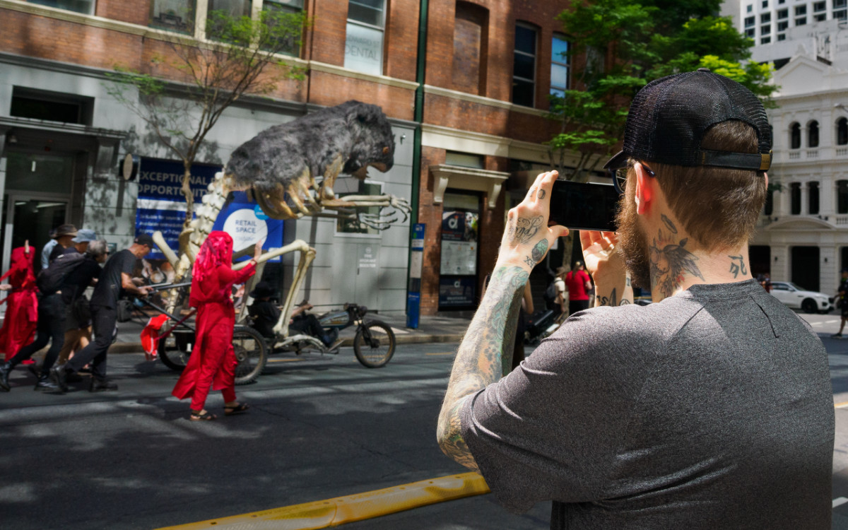 A bystander photographs Blinky and Red Rebels