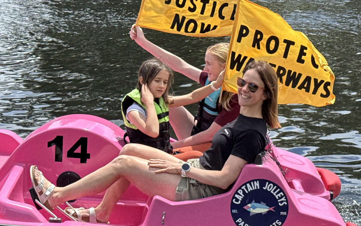 A family in a paddle boat join the protest