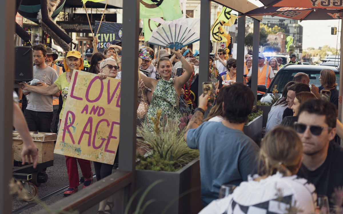 DISCObedience dancing protest passing a cafe
